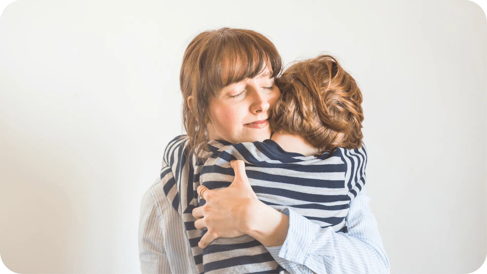 A mother hugging her child.