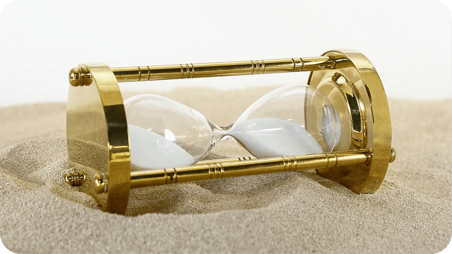 Gold side timer laying sideways on some sand.